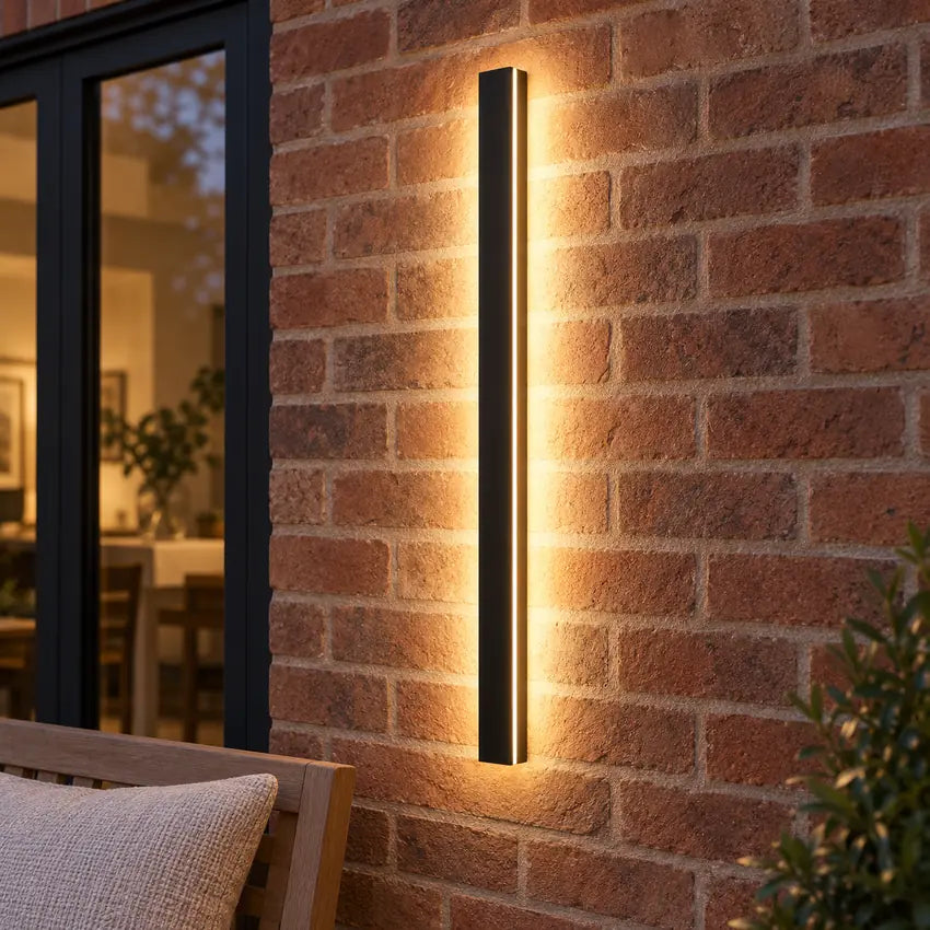 SilexStone black outdoor wall light with warm white light on a brick garden patio