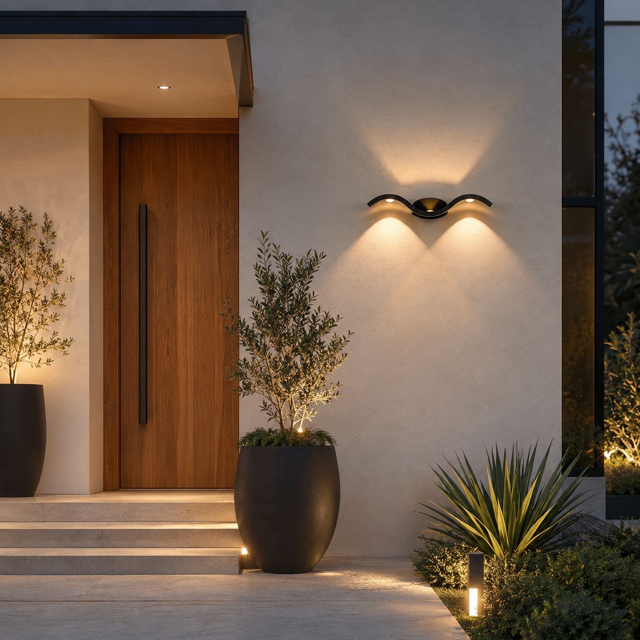 Wave wall light on white render above steps to a timber door with olive trees