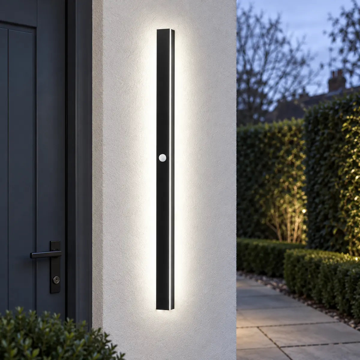 SilexStone black outdoor wall light with white light and motion sensor at a side entrance