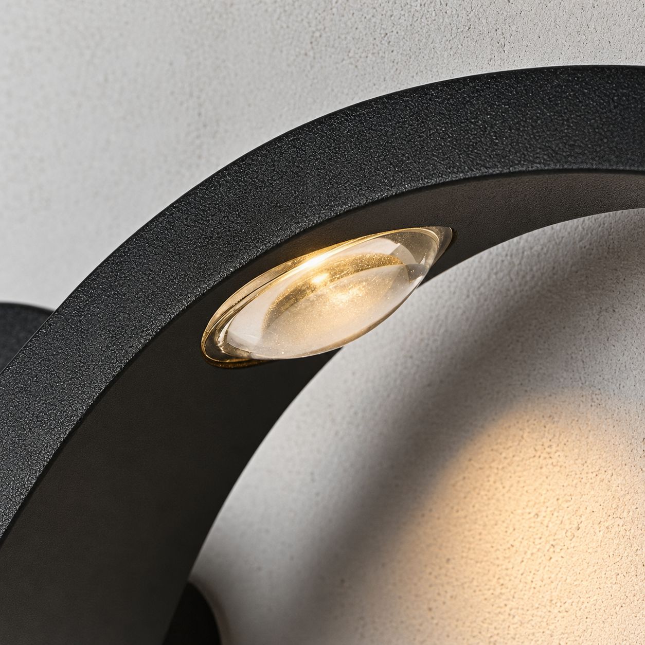 Macro detail of a single LED lens set into the curve of the wave sconce