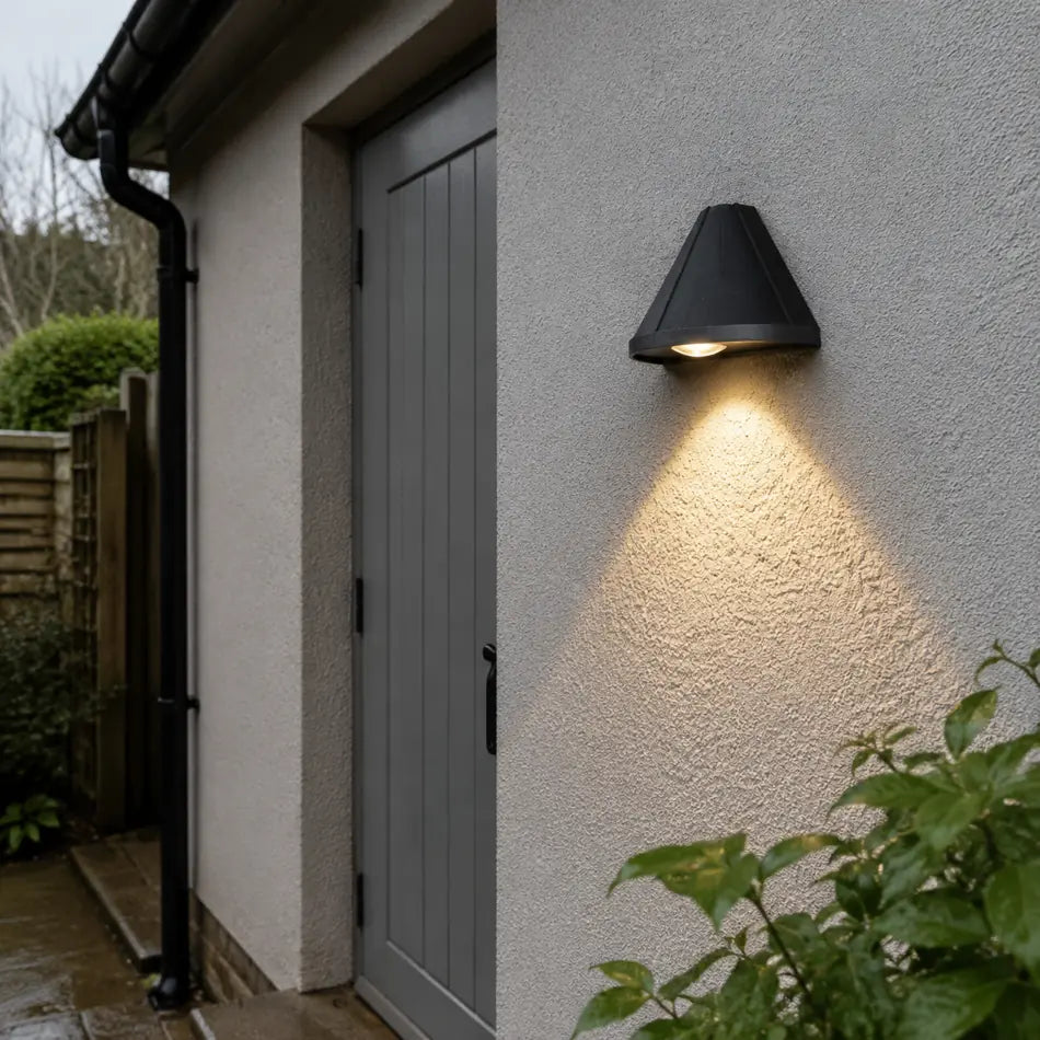 Black Luminara cone wall lamp beside a grey side door