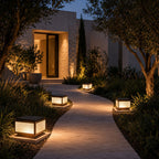 Post cap lights lining a path to a modern entrance at dusk