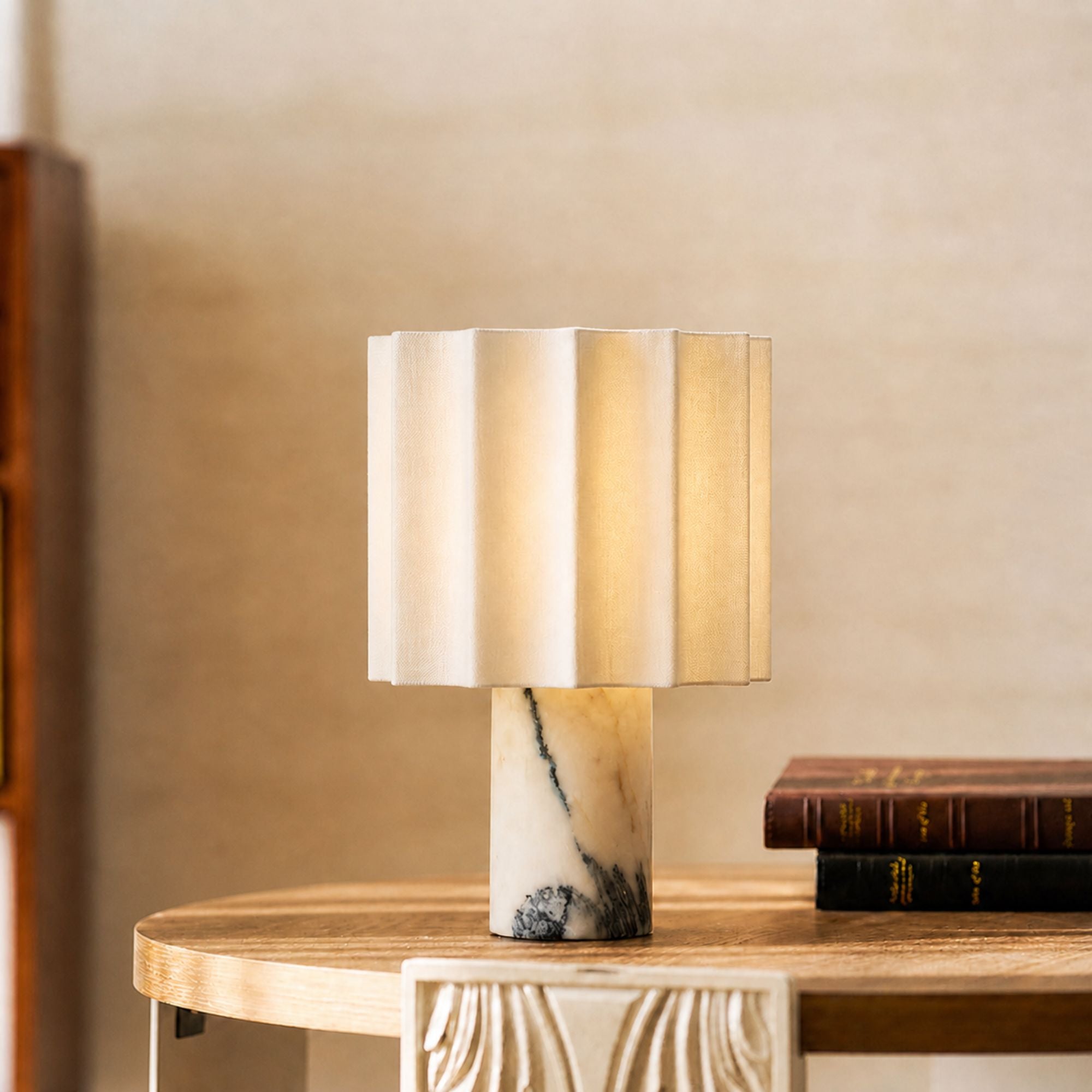Portable Calacatta marble table lamp with linen shade on side table creating warm ambient lighting