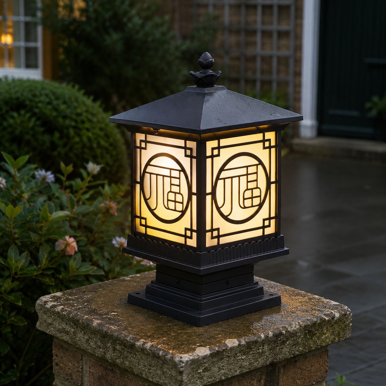 Tall fretwork lantern post cap lit on a mossy stone pier at dusk