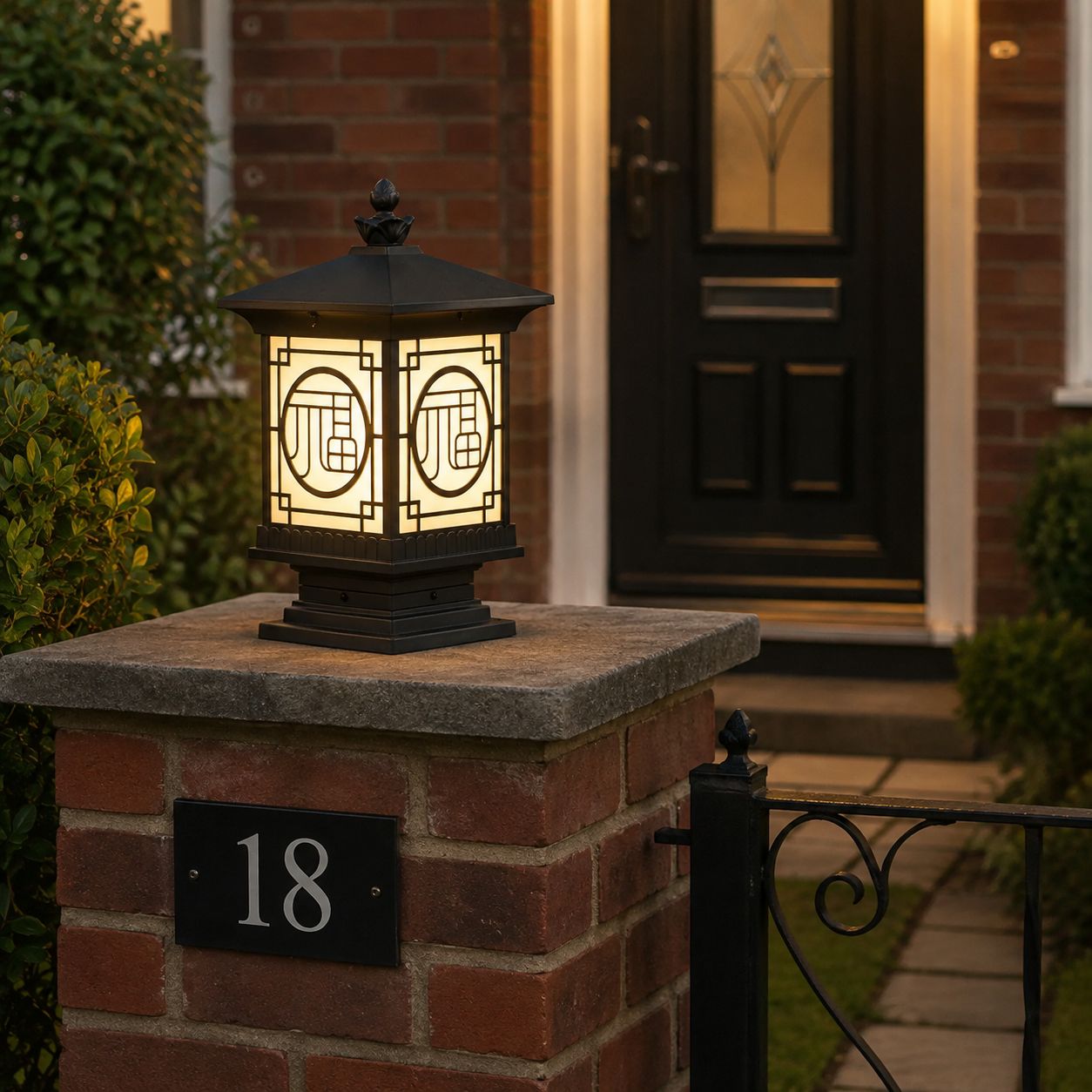 Tall lantern post cap on a brick pier beside a house number eighteen