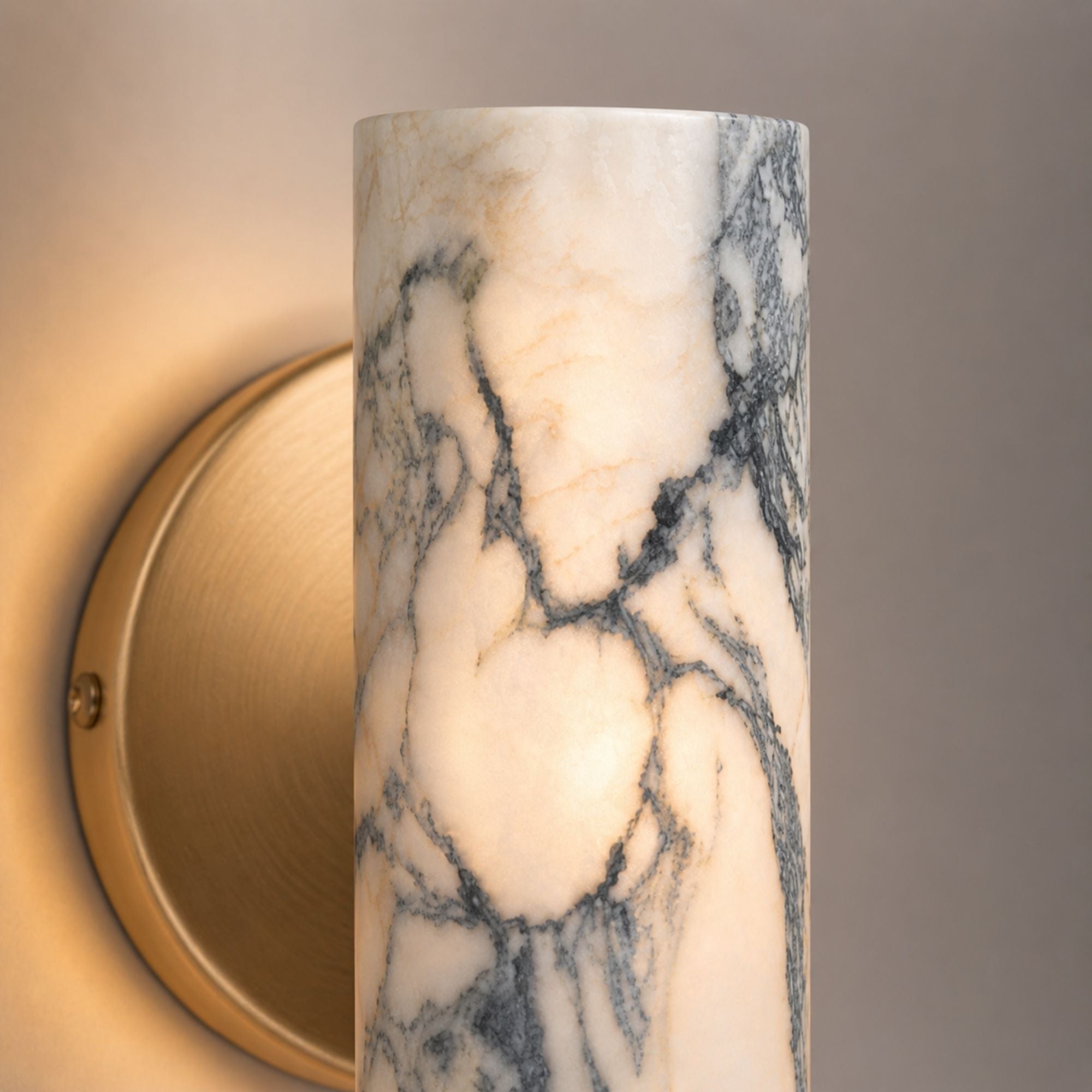 Close-up of marble wall lamp with natural stone veining and brass detail