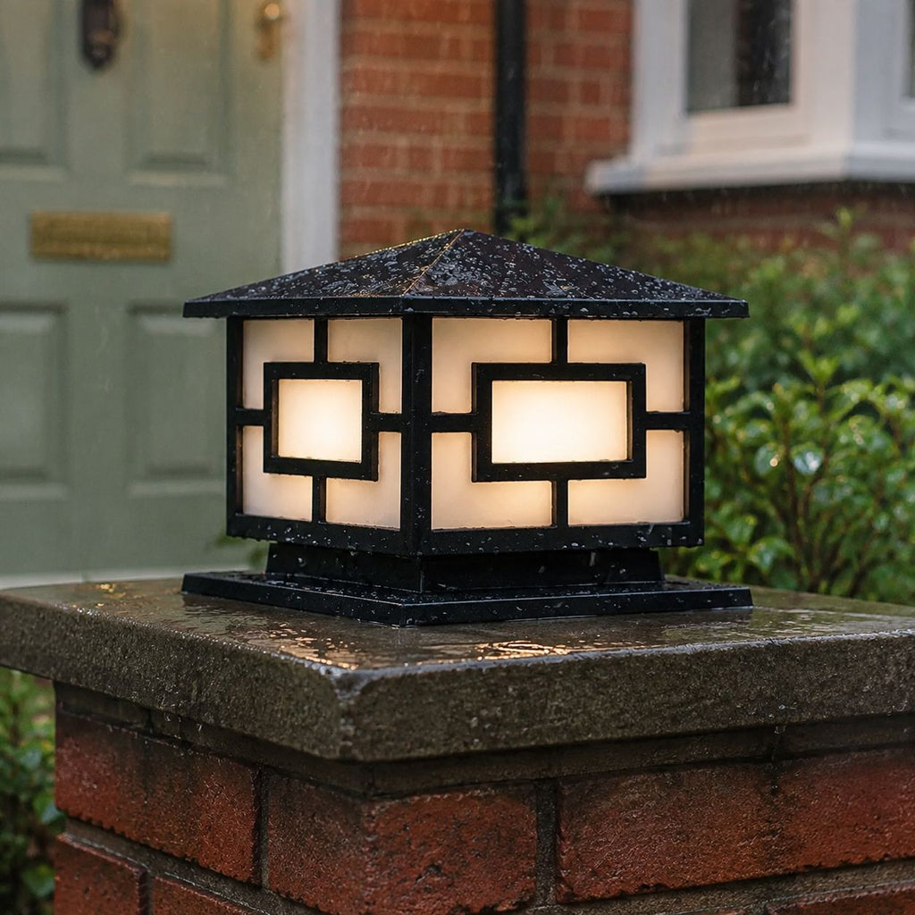 Pagoda pillar light on a mossy brick pier beside a green front door