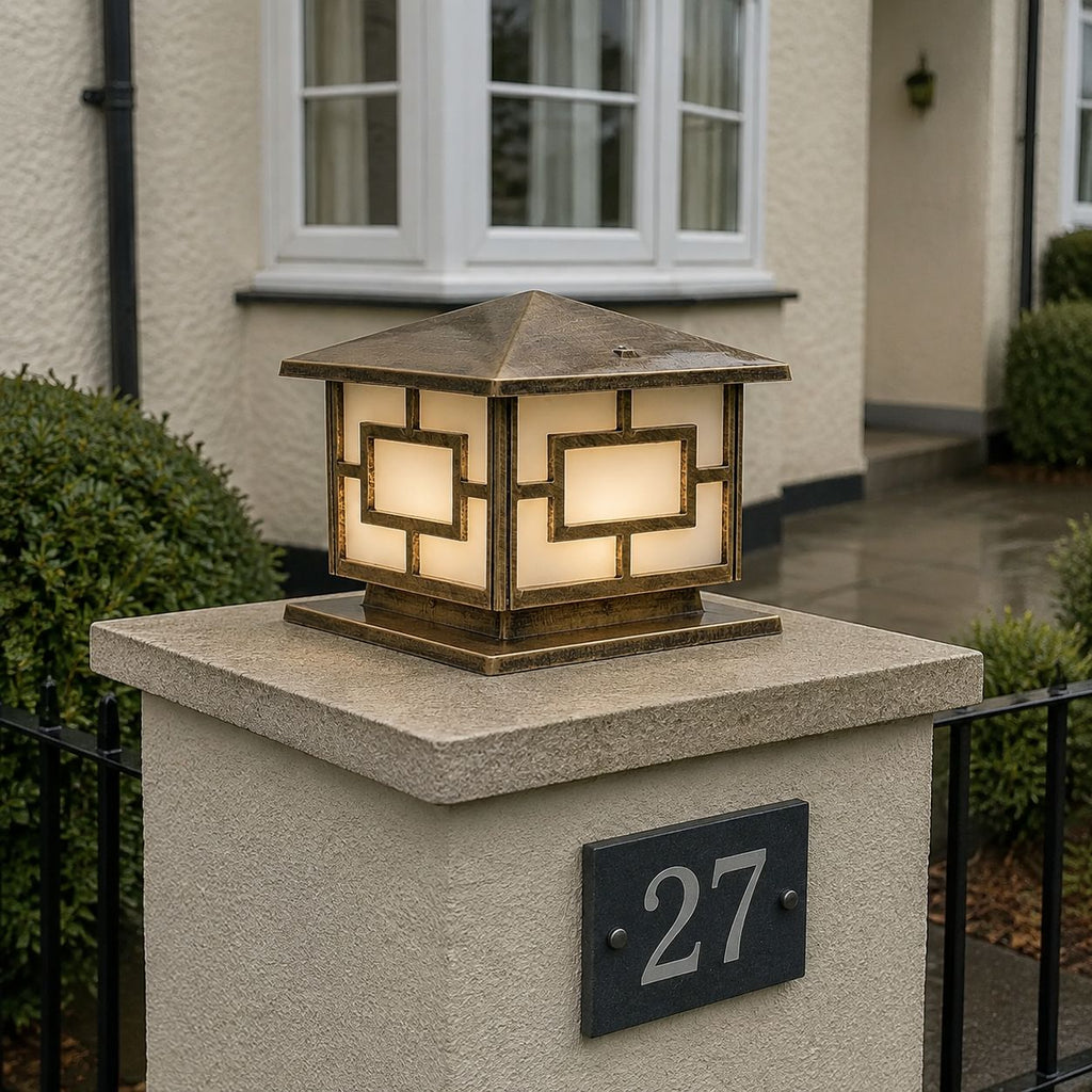 Pagoda pillar light on a stone pier beside a house number plaque