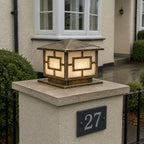 Pagoda pillar light on a stone pier beside a house number plaque