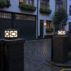 Pair of Pagoda pillar lights on dark piers at a cobbled mews entrance
