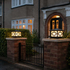 Two pagoda pillar lights on brick piers flanking an iron gate at dusk