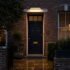 Rotating linear wall light above a dark front door on wet paving