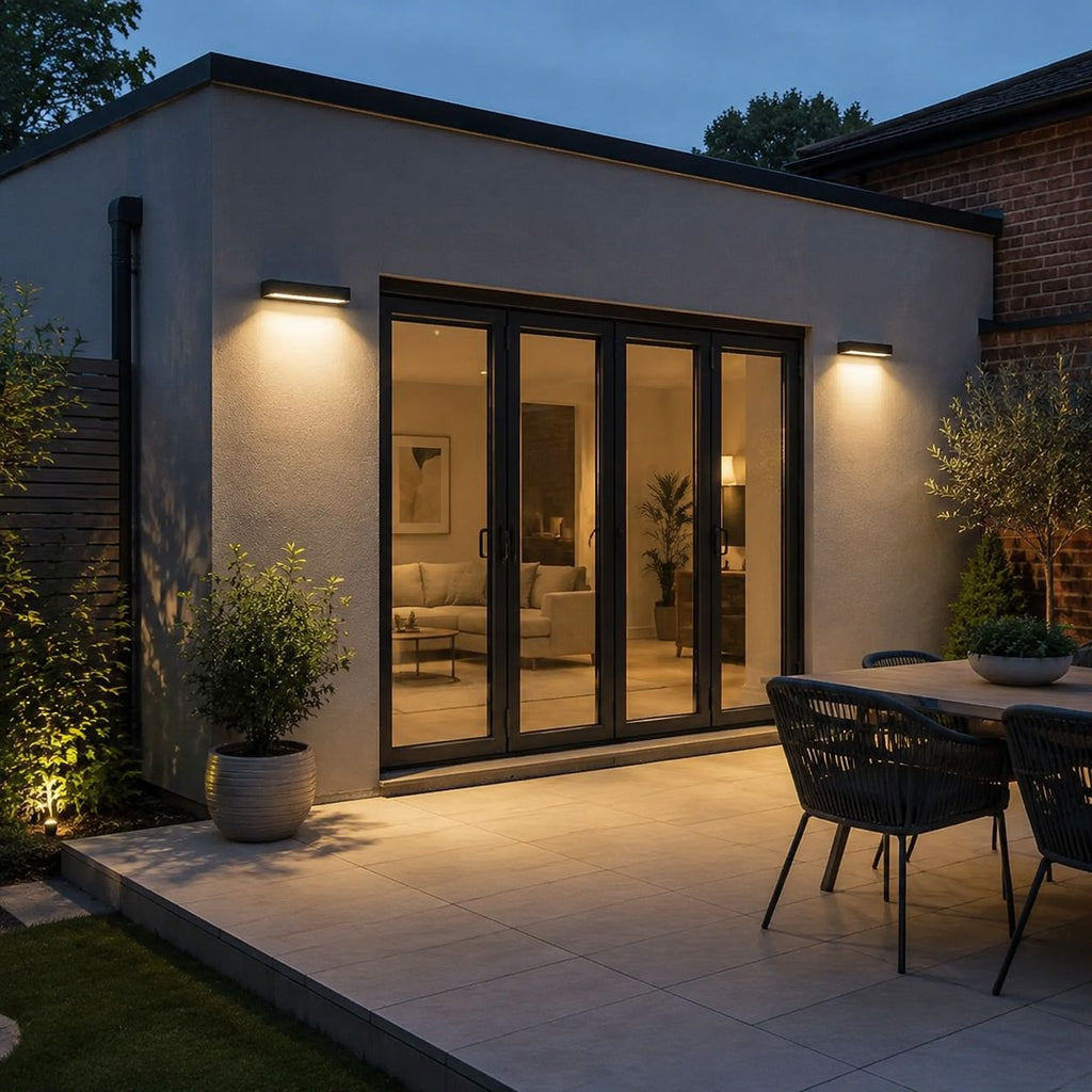 Linear wall light washing a paved terrace with outdoor chairs