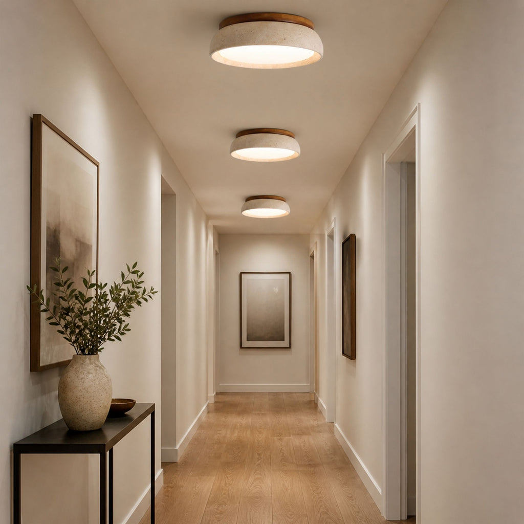 Travertine ceiling lights in beige natural stone and wood finish aligned in modern hallway with warm LED illumination