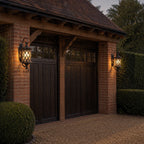 Lattice wall lantern beside a garage door and gravel driveway