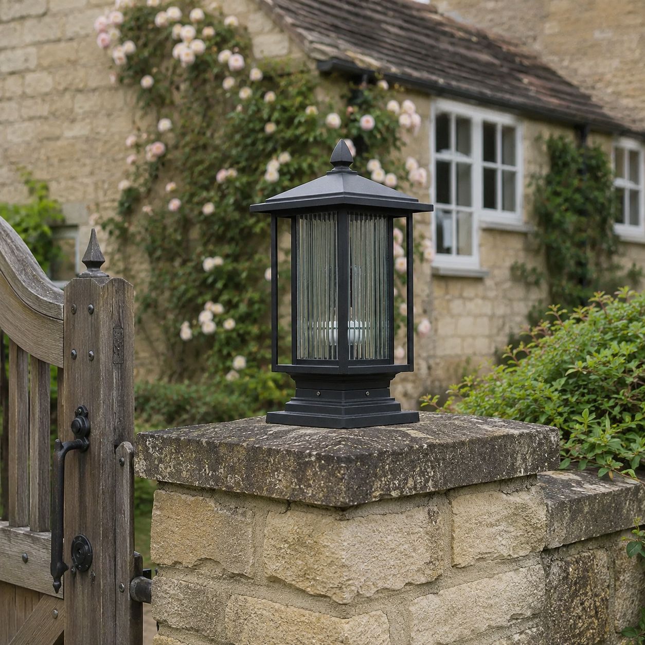 Ribbed glass post cap lantern on a stone pier beside a timber gate