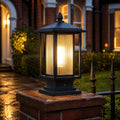 Ribbed glass post cap lantern lit on a brick pier at dusk