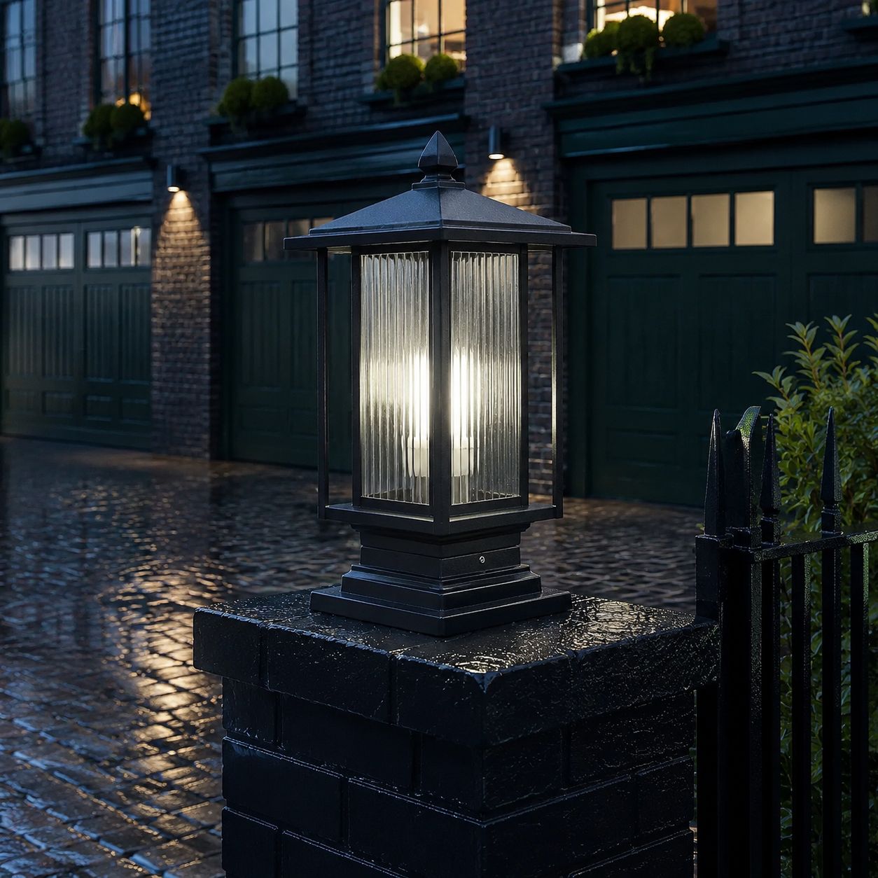 Ribbed glass post cap lantern on a dark pier beside a green garage door