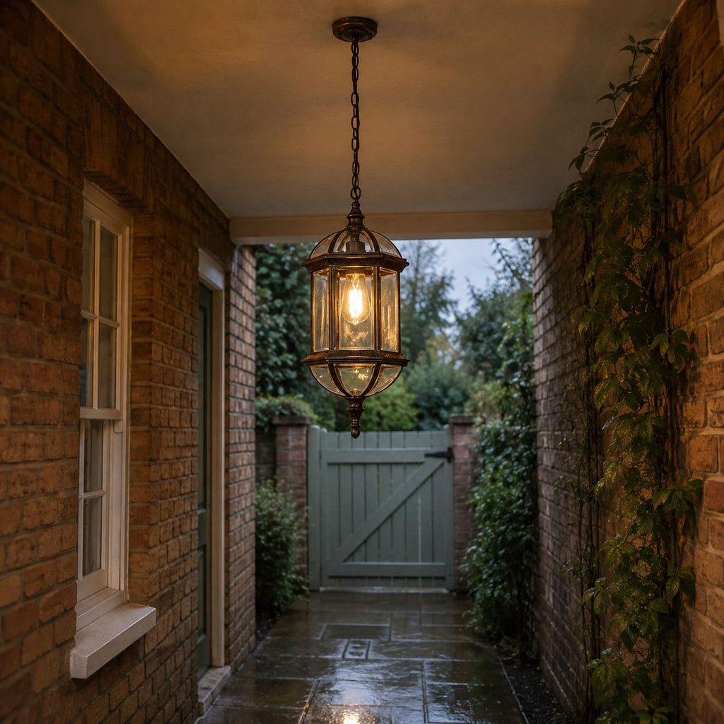 Domed pendant lantern lighting a covered brick passage to a garden gate