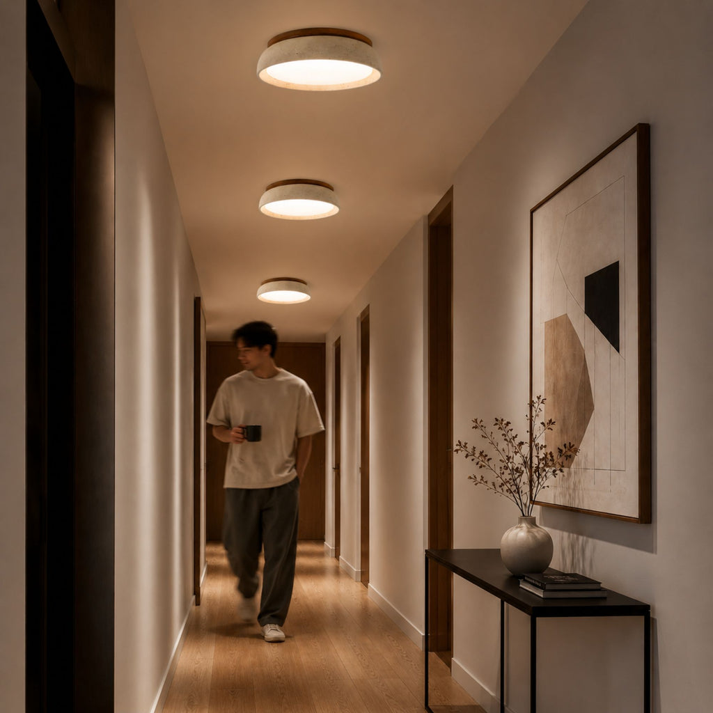 Elegant flush mount travertine ceiling lighting in a warm neutral hallway with modern decor styling