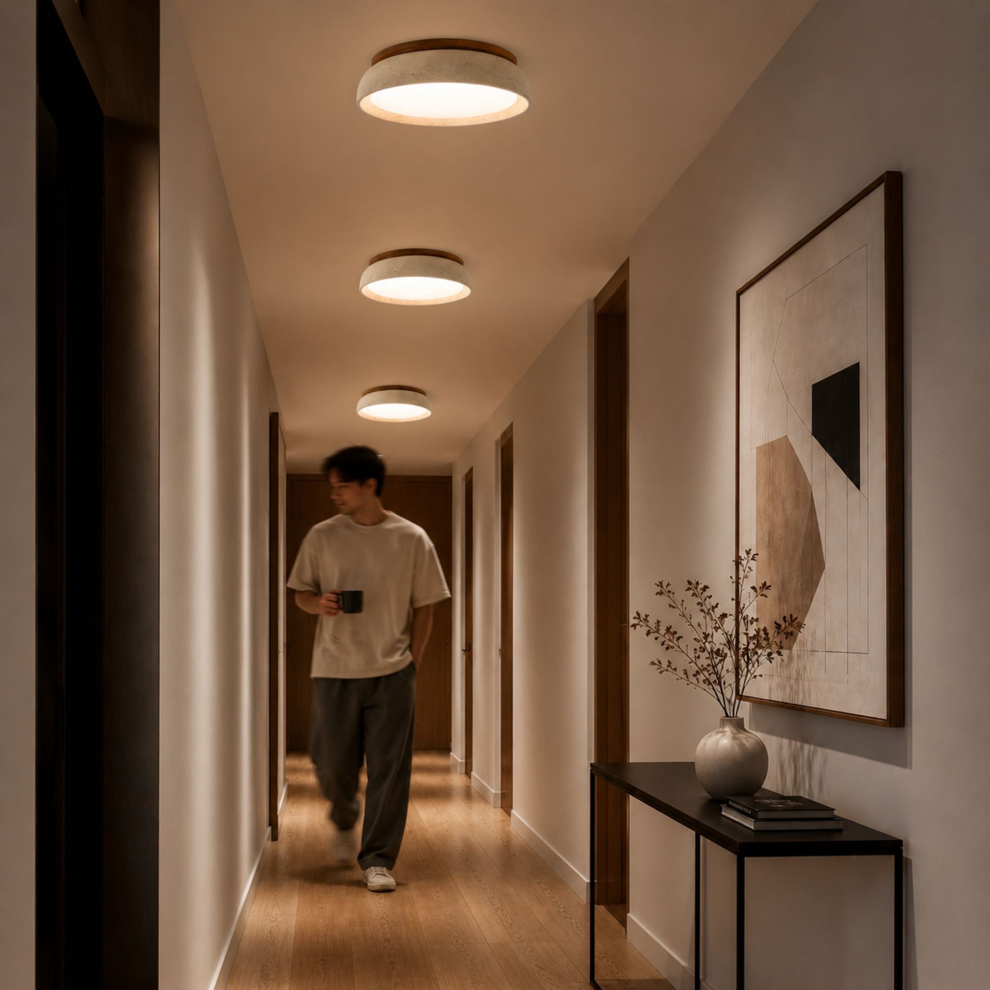 Elegant flush mount travertine ceiling lighting in a warm neutral hallway with modern decor styling