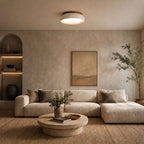 Minimalist travertine ceiling light in beige natural stone and wood finish illuminating elegant living room with warm ambiance