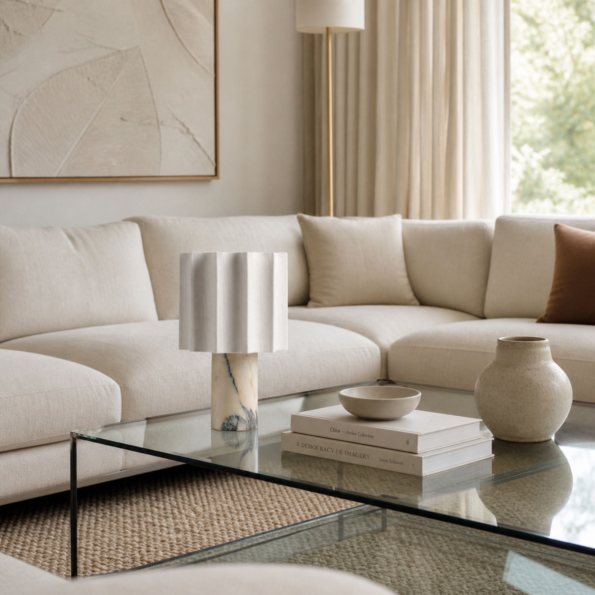 Calacatta marble table lamp with linen shade on wooden side table in cozy modern living room setting
