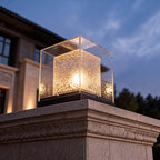 Post cap light against a twilight sky, clear outer housing catching the light