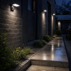 Angled LED wall light on dark brick lighting a narrow side passage