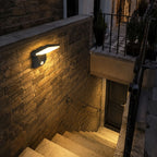 Angled LED wall light on a stone wall above basement steps