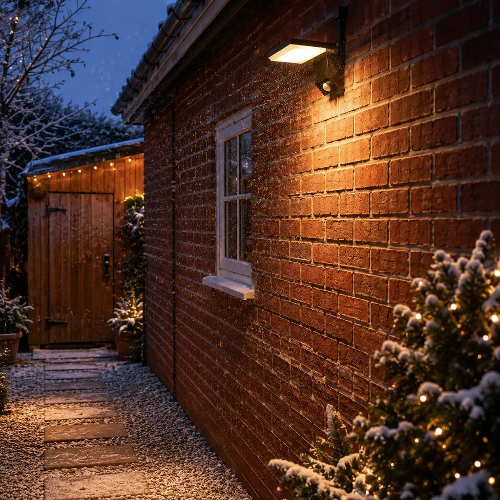 Angled LED wall light lighting a garden path at night