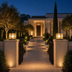 Two pillar lights on stone gate piers at the entrance to a modern villa