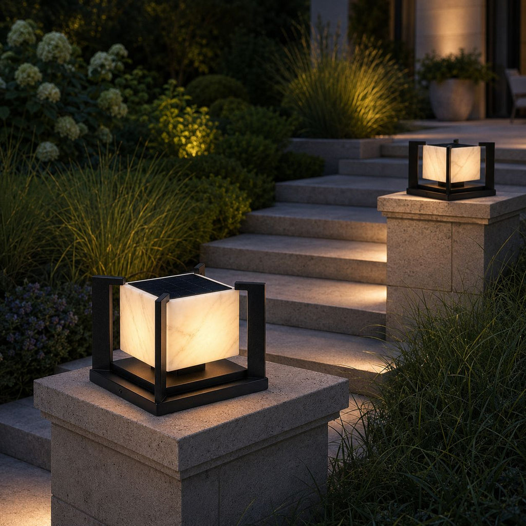 Two marble pillar lights on stone piers beside planted garden steps
