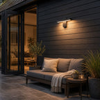 Linear LED bar wall light above outdoor seating on dark cladding