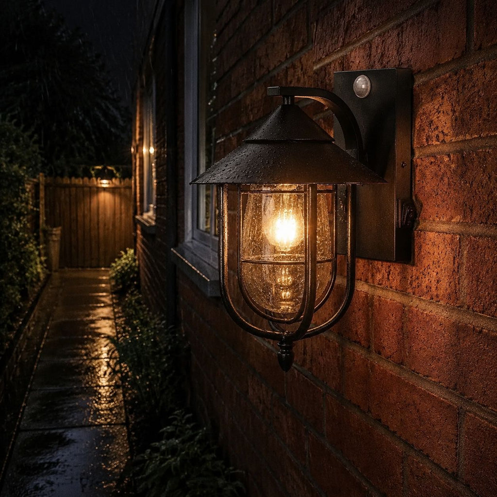 Nautical caged sconce lighting a wet brick passage at night