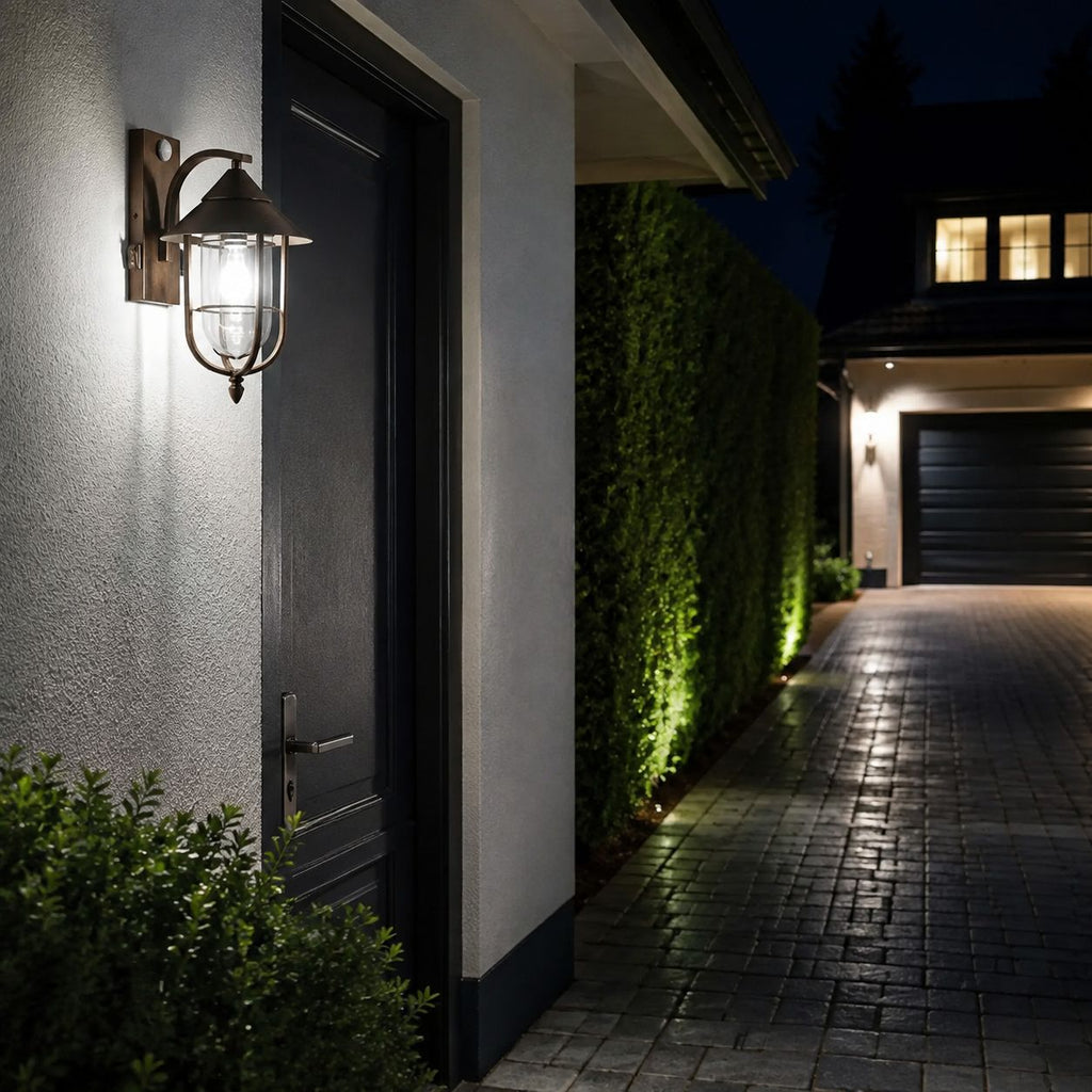 Nautical caged sconce on render beside a driveway and garage at dusk