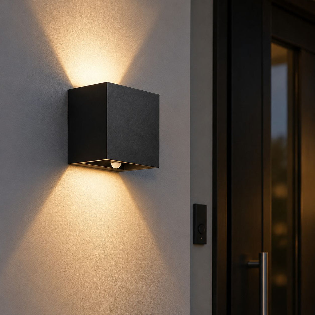 Compact up and down wall light beside a glazed front door