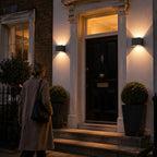 Two up and down wall lights either side of a black Georgian front door