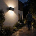 Up and down wall light detecting a person walking up a garden path at night