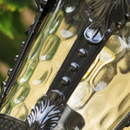 Macro of the rippled hammered glass panel and studded metal frame