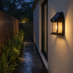 Solar motion sensor lantern lighting a narrow side passage in the rain