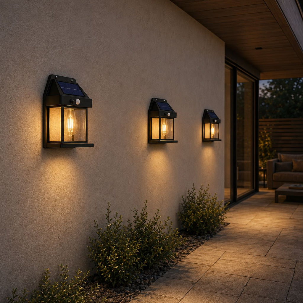 Three solar wall lanterns along a rendered wall beneath a timber soffit