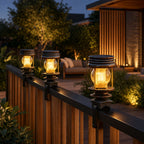 Solar lanterns clamped along a timber and metal deck rail beside a patio