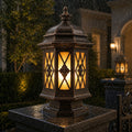 Hexagonal pillar lantern lit in heavy rain on a dark granite pier