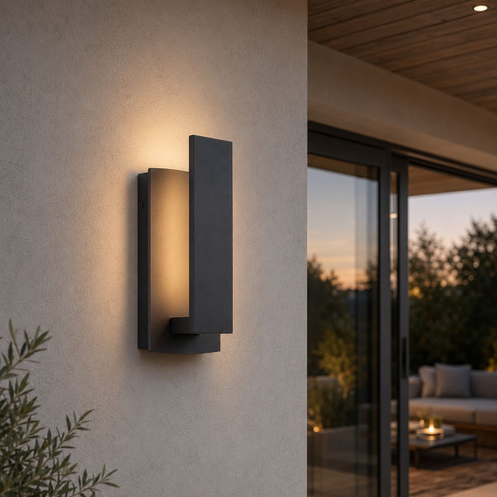 Black LED wall light on a rendered wall beside sliding doors to a patio lounge at dusk