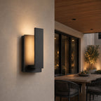 Angled close-up of the slim wall light on white render beneath a timber soffit