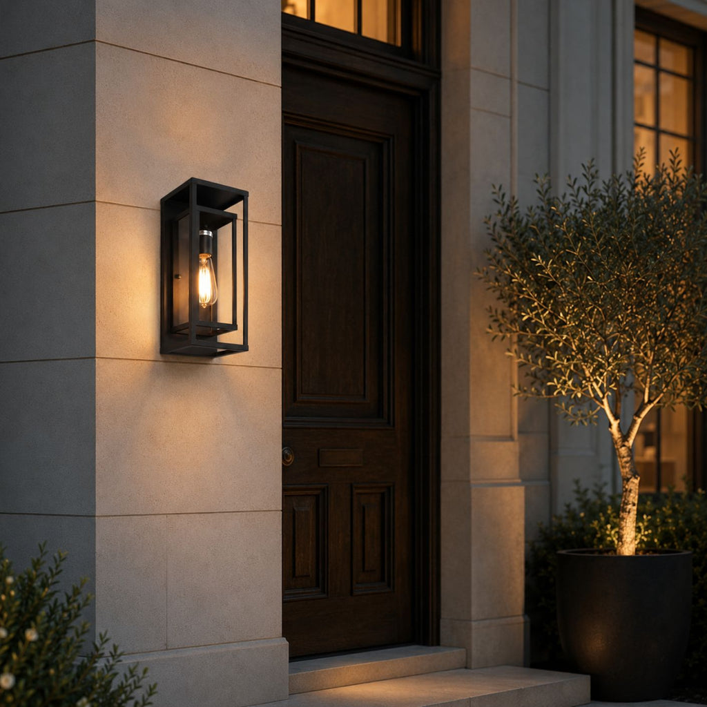 Matte black outdoor wall sconce on a cream stone wall beside a dark timber front door