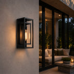 Black tempered glass wall sconce on a rendered wall beside sliding doors to a patio lounge