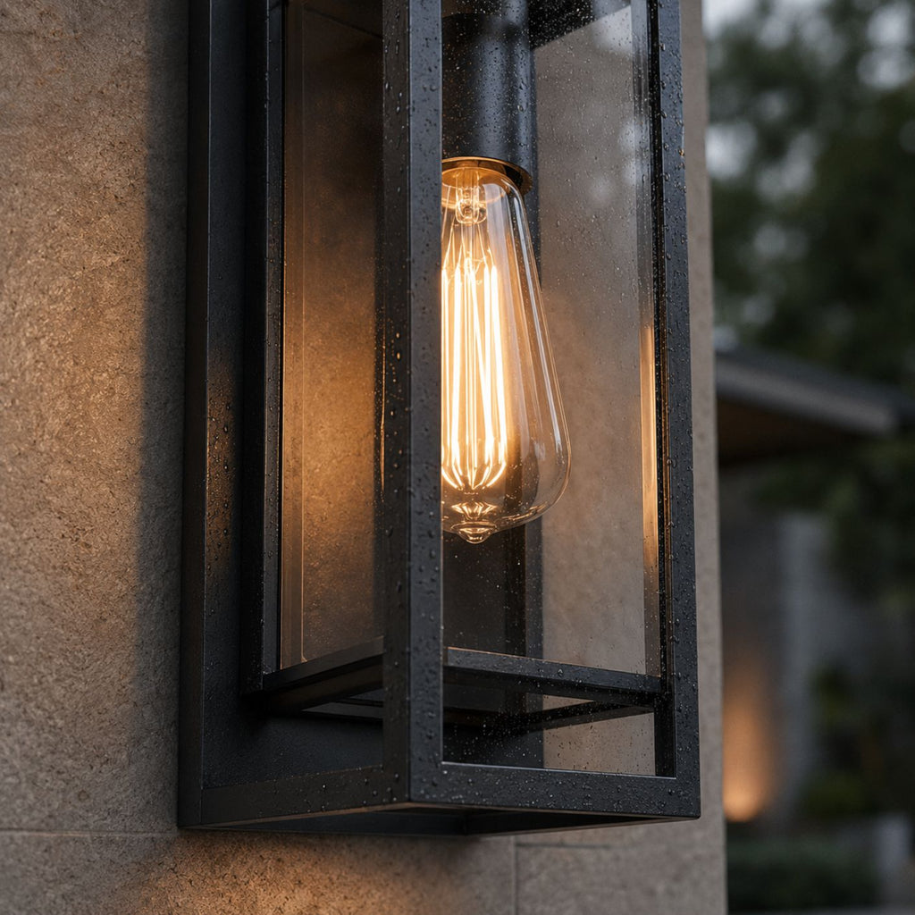 Close-up of rain on the tempered glass and frame, with the filament bulb lit inside
