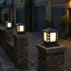 Three slatted post cap lights on stone piers along a cobbled mews at dusk